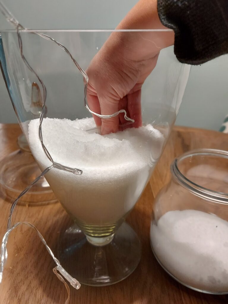 hand in glass vase adding salt