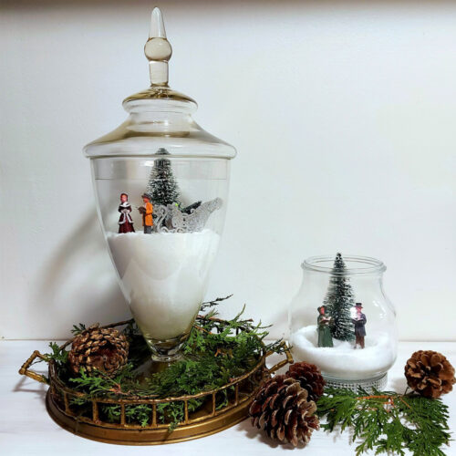 glass vase and jase with salt and christmas figurines inside