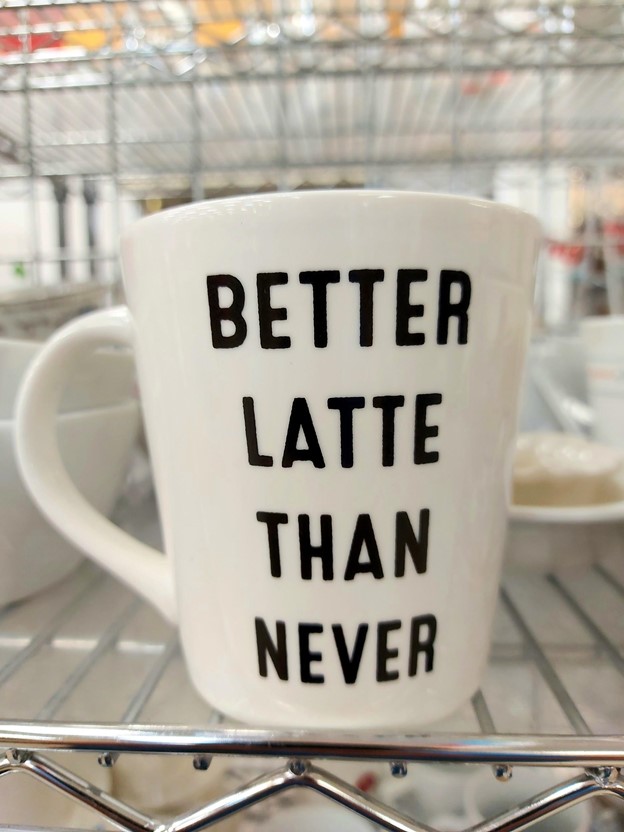 Thrifted coffee mug with quote: Better latte than never