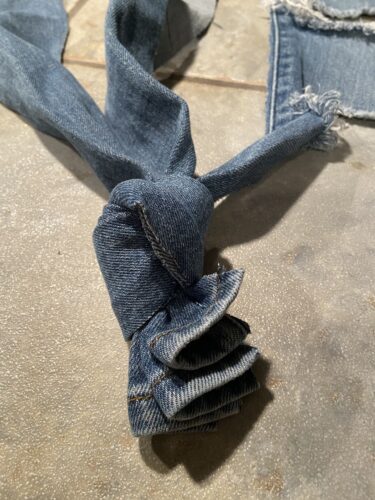 Denim jean strips with knot at one end tying them together