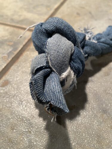 Denim jean strips knotted together at end to create finished DIY dog toy