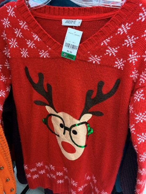 Red Christmas sweater featuring deer with glasses