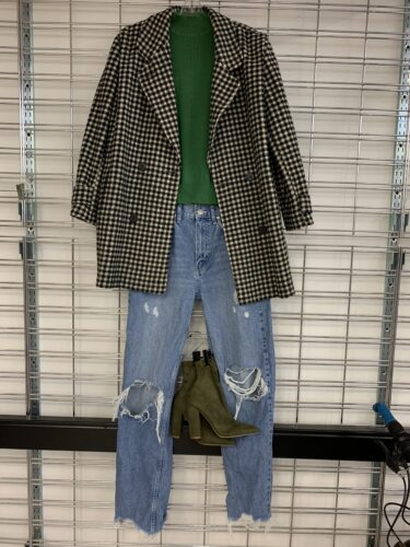 cute women's outfit for fall and winter holiday weather featuring patterned blazer jacket, green cozy shirt, ripped denim blue jeans, and green heeled boots