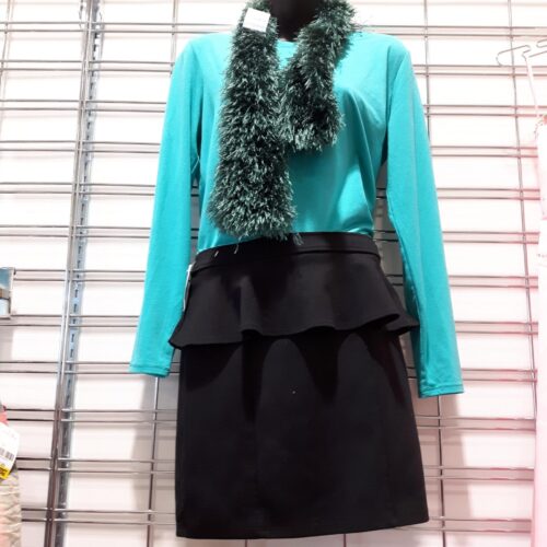 thrift holiday outfit inspiration with black skirt and blue green top, with garland as necklace