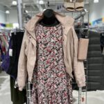 floral pink dress pictured on rack inside store with pale pink jacket layered overtop as clothing outfit thriftspiration