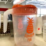 plastic beverage jug with orange lid for summer fun on the patio