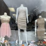 variety of dresses on display in the window of georgetown thrift store as clothing outfit thriftspiration
