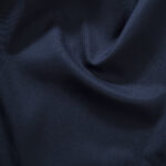 Impact report close-up photo of dark blue bedsheet