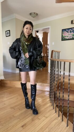 Anna wearing thrifted fall outfit featuring skirt, boots, jacket, and scarf