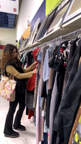 Come Thrift With Me for Holiday Gifts & Outfits - Camille browsing through clothing racks