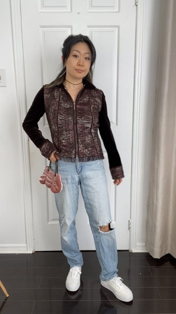 Anna wearing jacket with jeans and necklace, hair up with purse and white shoes - styled look #3