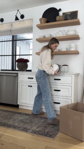 Clutter-Free February with Kassandra DeKoning as she packing plates into a box from her kitchen to donate