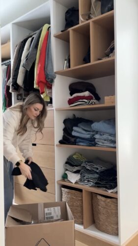 Clutter-Free February with Kassandra DeKoning as she packs clothes into a box to donate