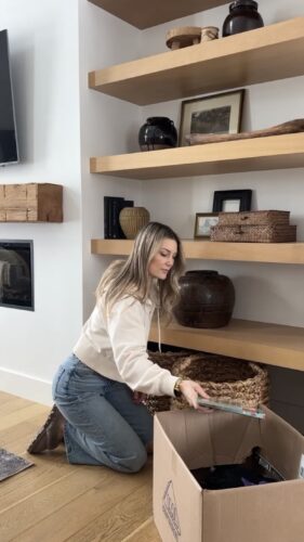 Clutter-Free February with Kassandra DeKoning as she puts houseware items into a box to donate