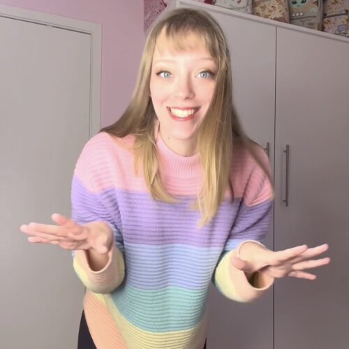 Jade wearing rainbow striped shirt