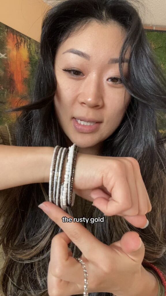 Anna holding thrifted bracelets