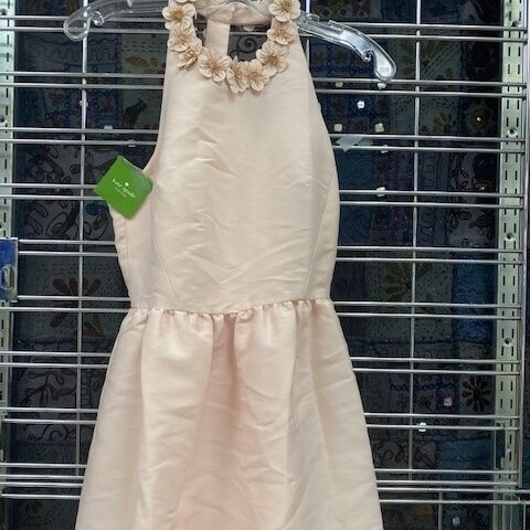 Pastel pink Spring Fashion Dress hanging on rack