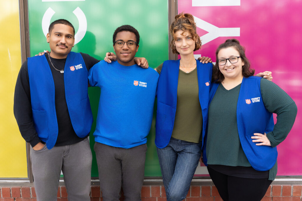 Diverse group of employees standing together in front of a Thrift Store