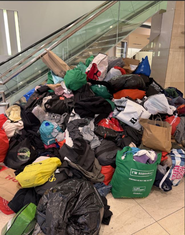 Many bags full of donations on the ground