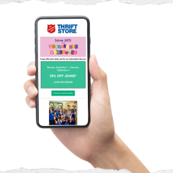Hand holding a phone displaying a Secondhand September email with coupon