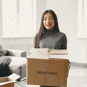 Woman holding box of donations Woman holding box of donations