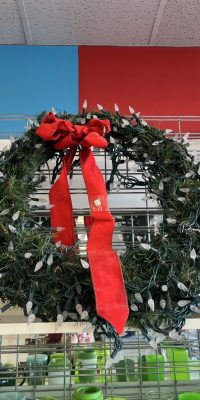 Christmas wreath with holiday lights and red ribbon display