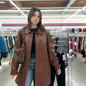Mikaela thrifting a brown coat